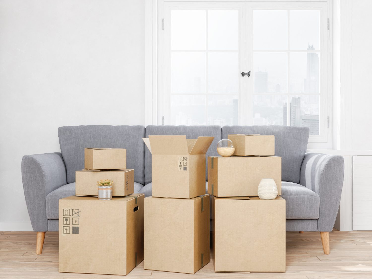 Moving boxes and sofa at new apartment